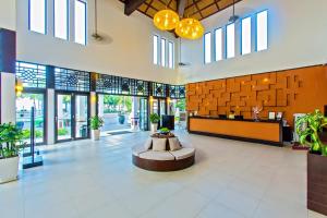 a lobby with a fountain in the middle of a building at Hoi An Beach Resort in Hoi An