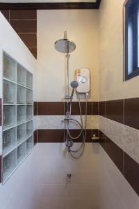 a shower in a bathroom with a shower head at The Best Ao Nang Villas in Ao Nang Beach