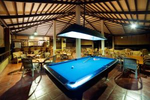 a pool table in a restaurant with tables and chairs at Hotel Elephant Reach in Yala
