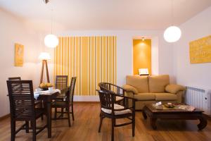 a living room with a couch and a table and chairs at La Fonda de Bustio in Bustio