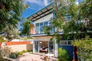 a house with a balcony and a bed in it at BIG4 Middleton Beach Holiday Park in Albany