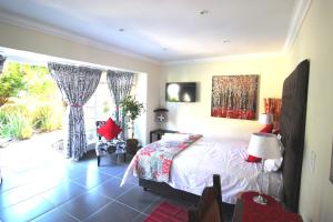 a bedroom with a bed and a window at House on Morninghill in Johannesburg