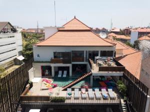 an aerial view of a house with a swimming pool at Cara Cara Inn in Kuta