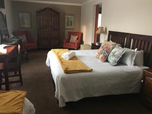 a bedroom with a bed with a towel on it at Tuscana Villa Guesthouse in Kroonstad