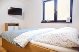 Posteľ alebo postele v izbe v ubytovaní Apartmány Na Čtvrtích