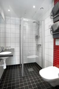 a bathroom with a toilet, sink, and shower at Connect Hotel City in Stockholm