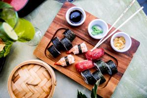 a cutting board with sushi and vegetables on a table at Ramside Hall Hotel, Golf & Spa in Durham