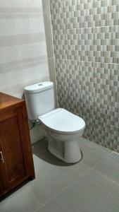 a bathroom with a white toilet in a room at Sunset Pandawa Villa in Ubud +91 photos