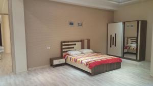 a bedroom with a bed and a large mirror at Charming 2 Bedroom Apartment near the City's Biggest Mall in Baku