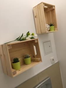 a wooden shelf above a toilet with potted plants at Centra and simple to reach in Vienna