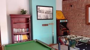 a room with a pool table and a book shelf at House on York in Johannesburg