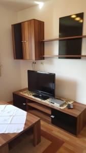 a living room with a desk with a television on it at Glaserhof in Gerlosberg