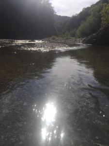 a river with the sun reflecting in the water at B B Griffondoro in Cantalupo Ligure