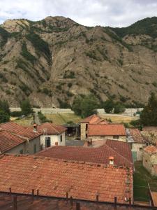 a village with red roofs and a mountain at B B Griffondoro in Cantalupo Ligure