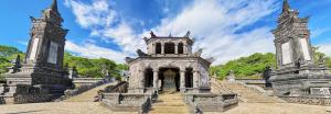 a stone building with stairs and two towers at Kha Hostel in Hue