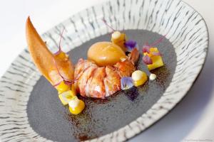 a plate with a piece of food on a table at Kameha Grand Bonn in Bonn