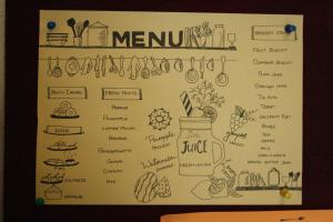 a whiteboard with a bunch of drawings of food at Hotel Stay Inn in Hyderabad