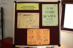 a bulletin board with some drawings on it at Hotel Stay Inn in Hyderabad