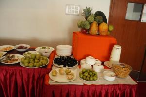 a table with plates of food on a red table at Hotel Stay Inn in Hyderabad