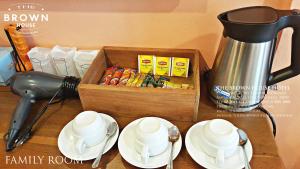 a wooden box sitting on top of a table with dishes at The Brown House Hotel in Chachoengsao