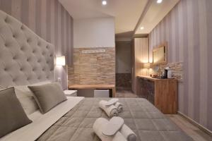 Ένα ή περισσότερα κρεβάτια σε δωμάτιο στο Veneto Suite Rome