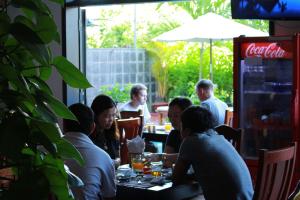 a group of people sitting at a table in a restaurant at Phuc Thao Villa in Hoi An