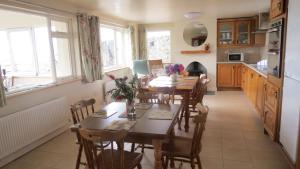 a kitchen and dining room with a table and chairs at Ocean View in Glandore