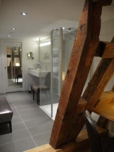 a bathroom with a glass shower and a sink at Hôtel Ettenheim in Strasbourg