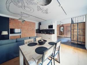 a living room with a table and a couch at Habitat Apartments in Kraków