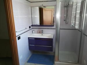 a bathroom with a sink and a shower with a mirror at B&B Angel's Dream in Porto Fuori