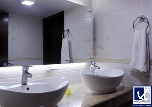 a bathroom with a sink and a mirror at Anchorage The Residence in Dhaka +60 photos