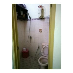 a bathroom with a toilet and a shower at Guest House Abimanyu in Kaliurang