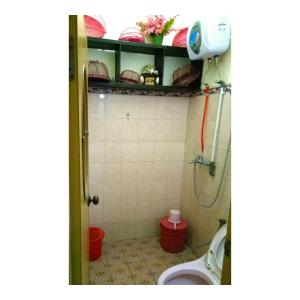a bathroom with a shower and a toilet in it at Guest House Abimanyu in Kaliurang