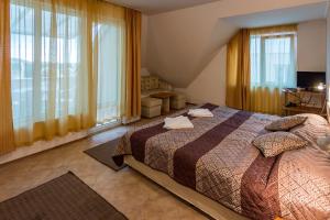 a bedroom with a bed and large windows at Hotel Tropics & Venera - Ultra All Inclusive in Sveti Vlas +42 photos
