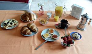 a table with plates of breakfast foods and drinks at Agriturismo I Gelsi di Santa Cristina in Gubbio