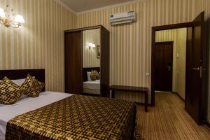 Voodi või voodid majutusasutuse Klassik Hotel toas