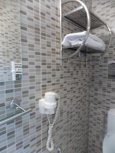 a shower with a phone in a bathroom at Pensiune Xe-Mar in Arad
