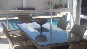 a glass dining table with chairs and a bowl on it at 51 Trafford in George