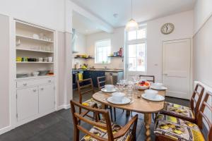 a kitchen and dining room with a table and chairs at Watermans in Aldeburgh