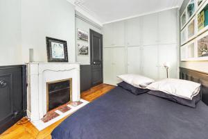 Katil atau katil-katil dalam bilik di Large & Bright Apartment, Central Paris, Montmartre-Opéra, Picturesque Rue des Martyrs