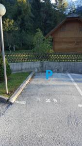 a parking lot in front of a house at Apartment HM in Gozd Martuljek