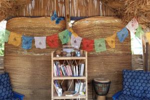 a room with a book shelf and a clothes line with towels at A&Y Wild Camp Ghana in Keta +64 photos