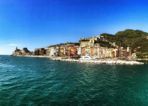 a city on top of a hill next to the water at La Taverna del Metallo Rooms in La Spezia