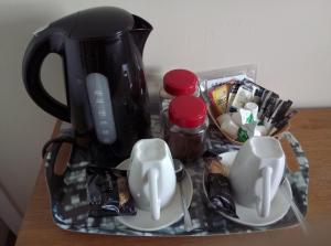 a tray with a coffee pot and cups on a table at Maggie's in Inveraray