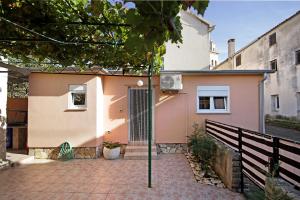 a house with a gate and a brick driveway at Apartment Vesna in Premantura