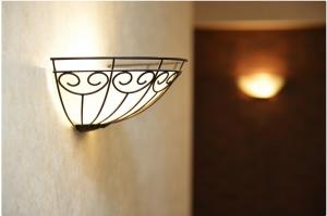 a light on the side of a wall at Apartment on Bulvar Mira 8 in Karagandy +1 photo
