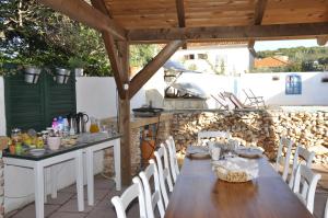 a wooden table and chairs on a patio at Villa Olma in Okrug Gornji