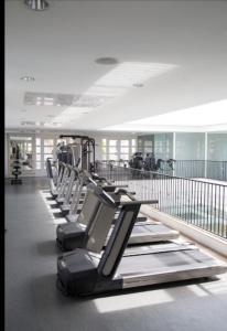 a row of empty treadmills in an airport gym at Il Campanario Villaggio room in Florianópolis