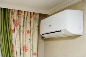 a printer hanging on a wall next to a curtain at Apartment on Pichugina in Karagandy