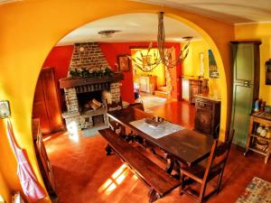 a dining room with a table and a fireplace at Casa Vacanza Pratolungo in Zogno